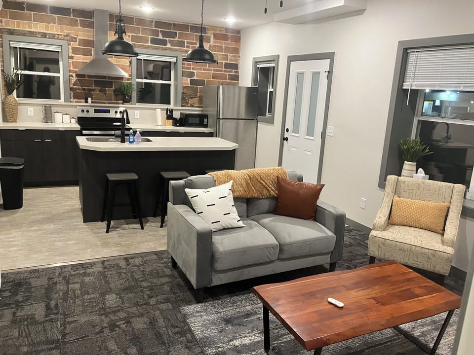 The open living room connected to kitchen to entertain family or relax.