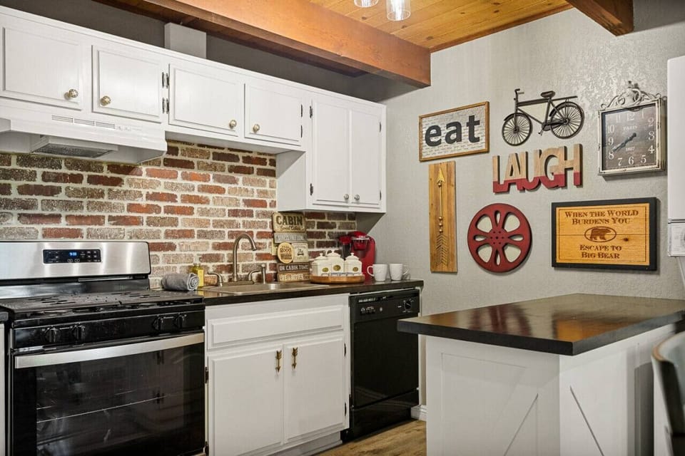 The kitchen is a charming mix of modern amenities and rustic details, with wooden cabinetry and a farmhouse sink.