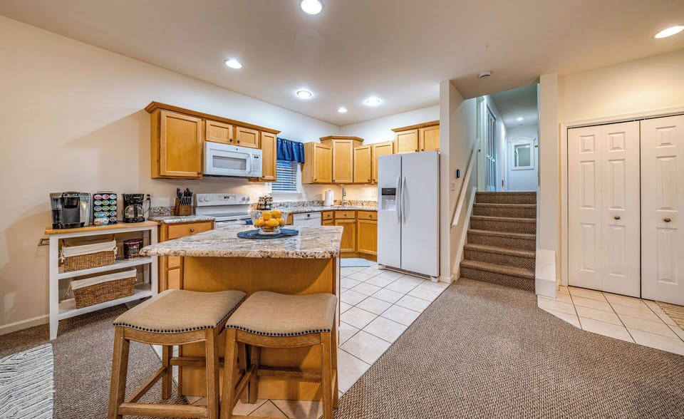 Polished kitchen with two seats by the kitchen island
