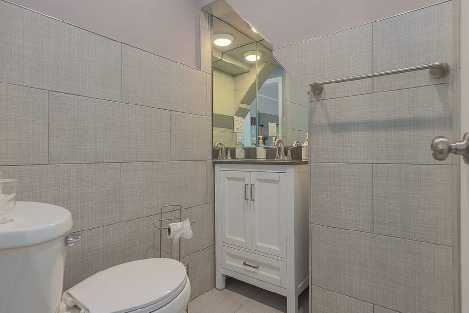 The bathroom in this room is private and small