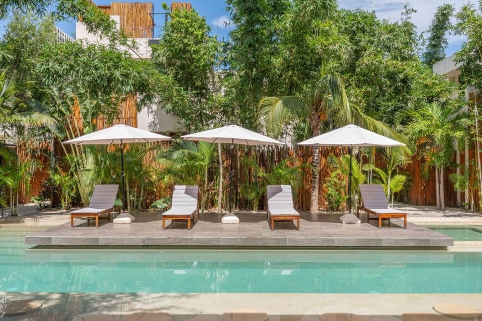 Relax poolside in a sunny shared space with seating