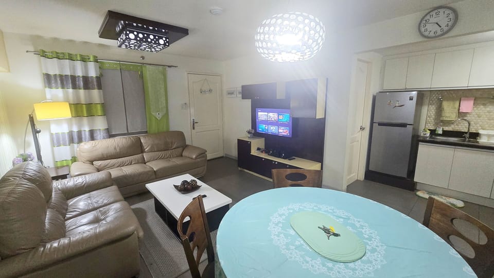 Luxury Condo, 2 Bedrooms, Balcony, Garden View | Living area | 40-inch LCD TV with digital channels, printers