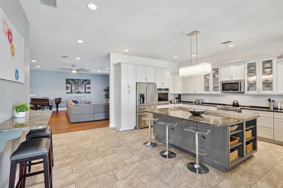 A bright, spacious kitchen with a grand island for cooking