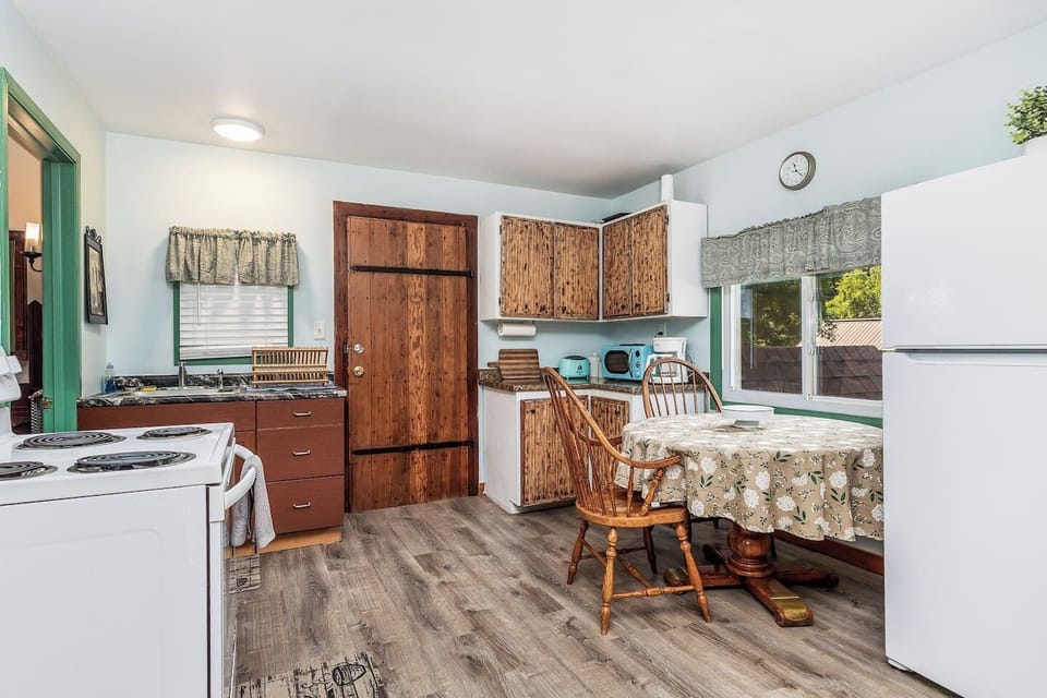 Nicely equipped kitchen: Stove, oven, refrigerator, microwave, coffee maker, toaster, wine glasses, and cooking basics