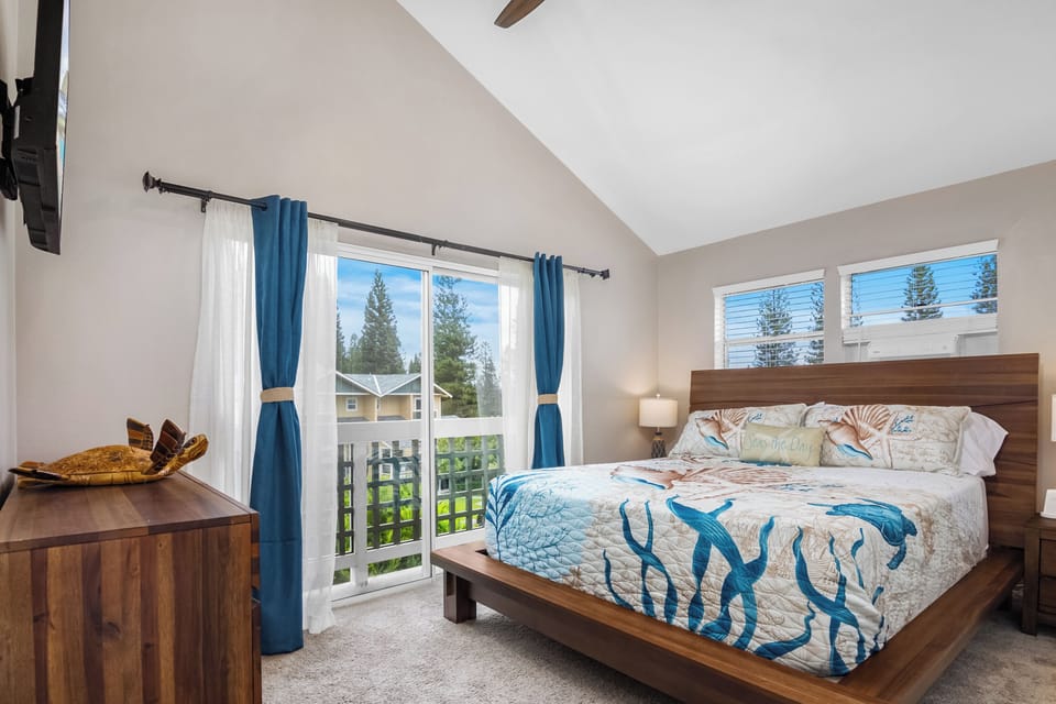 Enjoy the master bedroom featuring ocean-inspired furniture and a small balcony