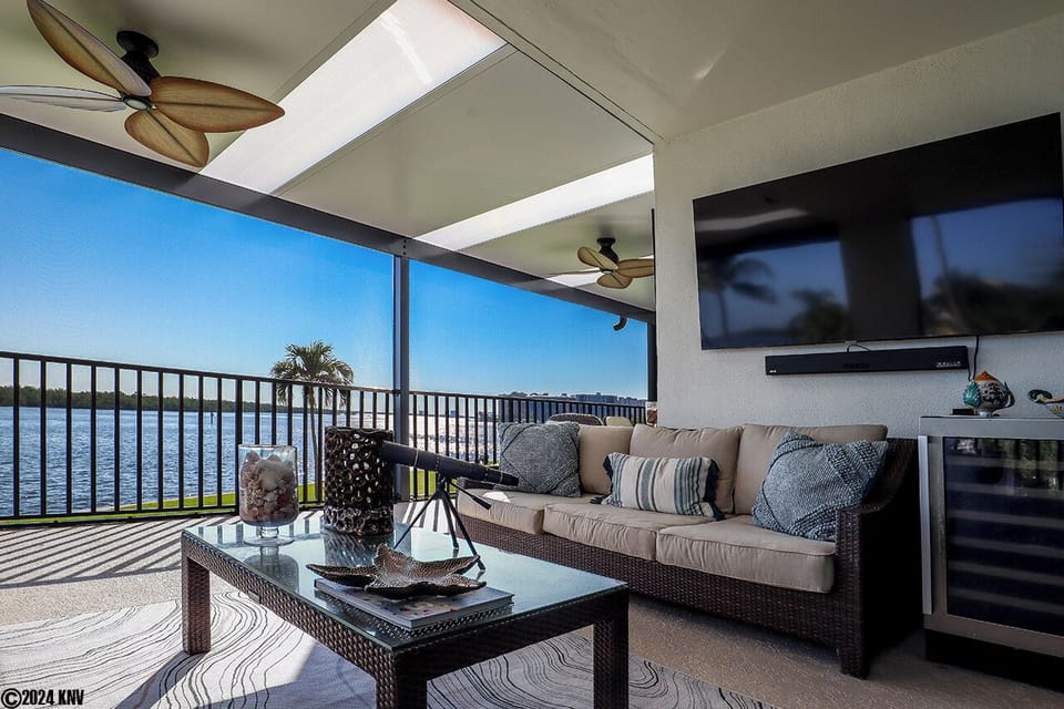 The fabulous Wrap Around, Screened In Lanai with the Million Dollar View offers the best in outdoor entertaining including a Huge Screen TV, Wine Fridge