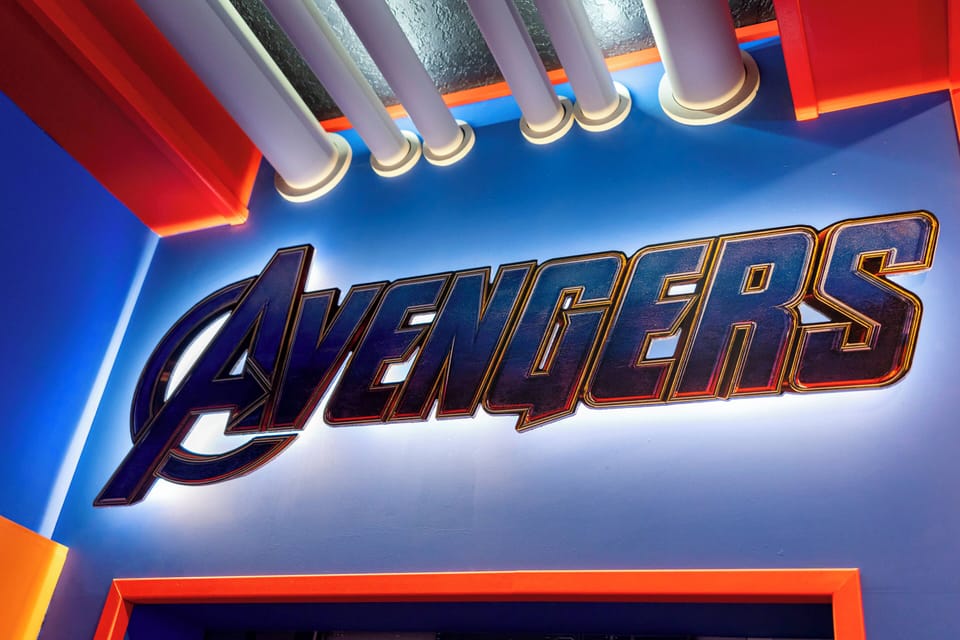 Step into a vibrant entertainment area featuring bold blue and red decor that sets an energetic tone. The striking "Avengers" sign adds a playful touch, perfect for fans looking to immerse themselves in a memorable experience.