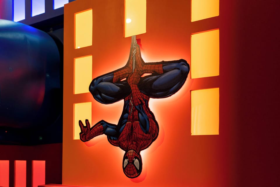 This vibrant room features a striking wall mural of a superhero, creating a playful atmosphere perfect for families or fans of comic book culture. Bold colors and dynamic imagery invite excitement, ensuring a memorable stay.
