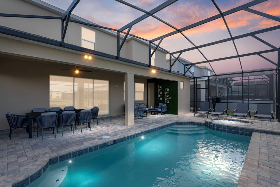 Enjoy a private pool area with sparkling water, stylish tiles, and cozy outdoor seating. As the evening light gently illuminates the space, it creates a perfect ambiance for relaxation and unwinding under the open sky.