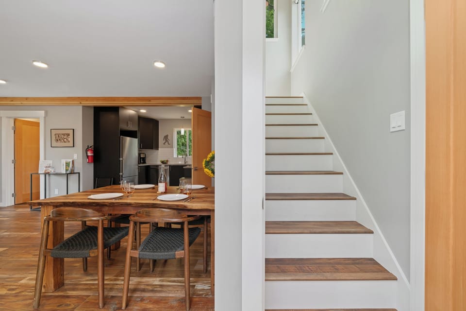 Stairs to the upper family suite bedroom with Queen and double bunk beds.