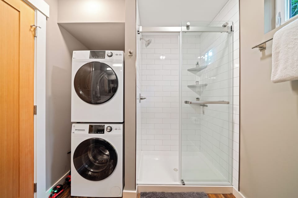 Main floor bath with walk in shower, stackable washer/dryer.