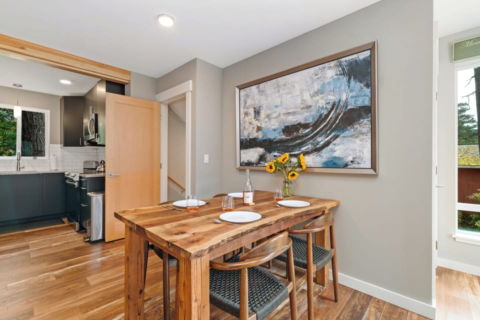 Dining room open to living room and kitchen with access to upper deck. Extra Table and chairs for dining in front closet.