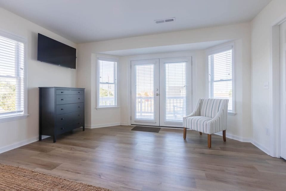 The primary bedroom has a 12" memory foam king-sized mattress, large bedroom, 1 closet for guest use (second closet is owner's closet), a TV, dresser, private balcony, and impressive en-suite.