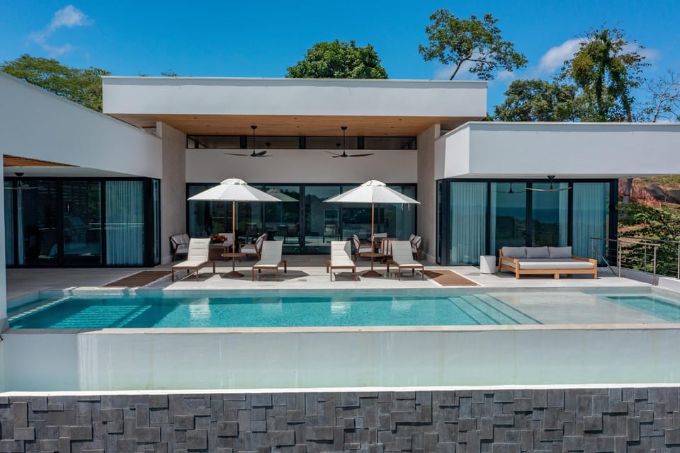 Drone shot looking back at the outdoor social area and pool
