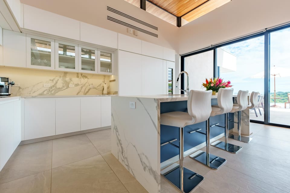 The custom Thermador fridge, freezer, and veritcal wine closet are seamlessly built into the cabinets