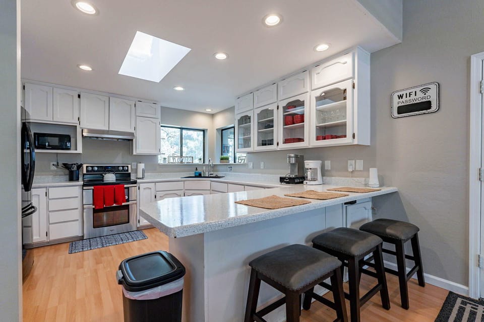 Well stocked kitchen with extra seating at the peninsula