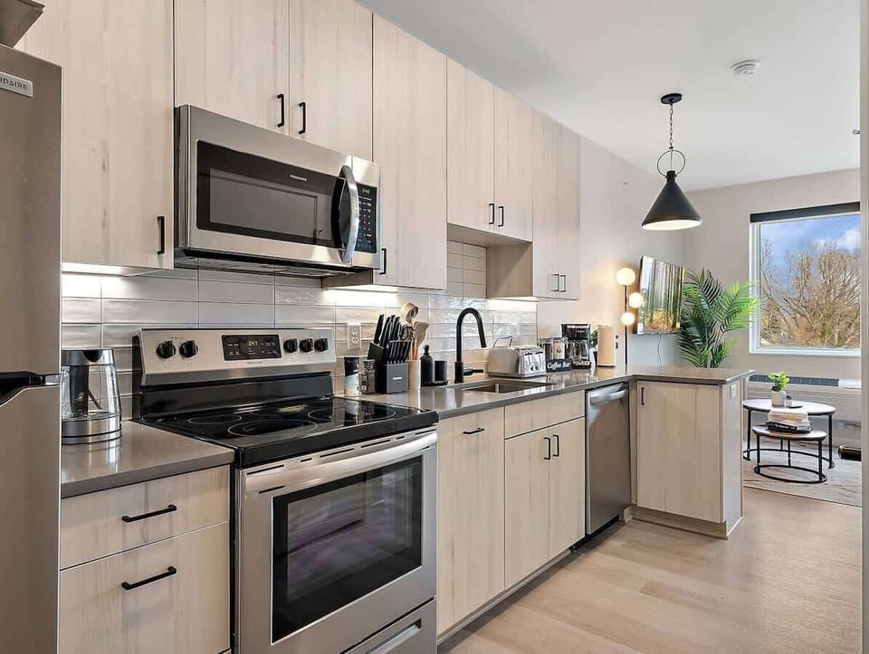 Fully equipped kitchen with modern appliances, sleek finishes, and natural light!