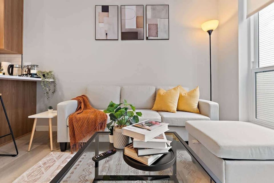 Cozy living space with chic decor, comfy sofa, and warm lighting for relaxation.