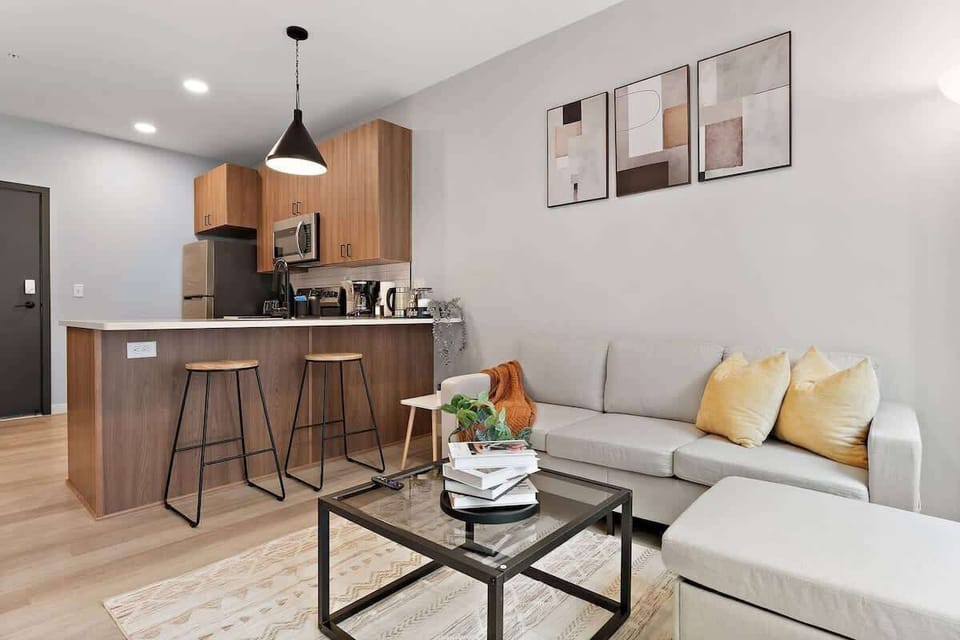 Stylish open-concept space with a modern kitchen, comfy seating, and chic accents.