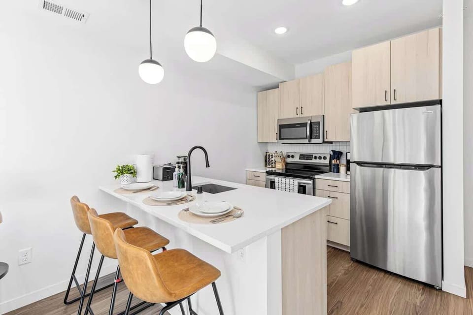 Fully equipped kitchen with dishwasher, microwave, fridge, stove, pots, pans, plates, dishes, cups, coffee maker and many more