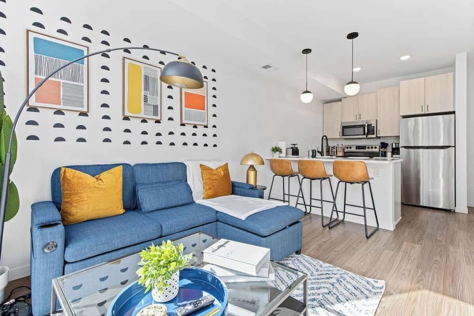 Modern open-concept space with cozy seating, chic kitchen, and stylish details.