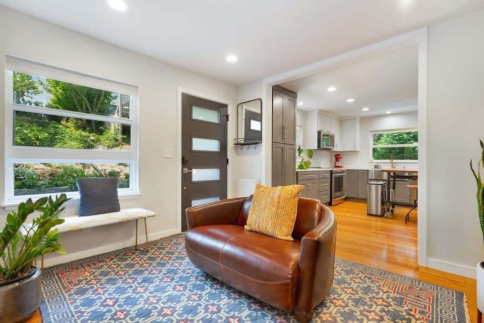 Open entryway with seating and windows. Easy access to the living and dining rooms from the door.