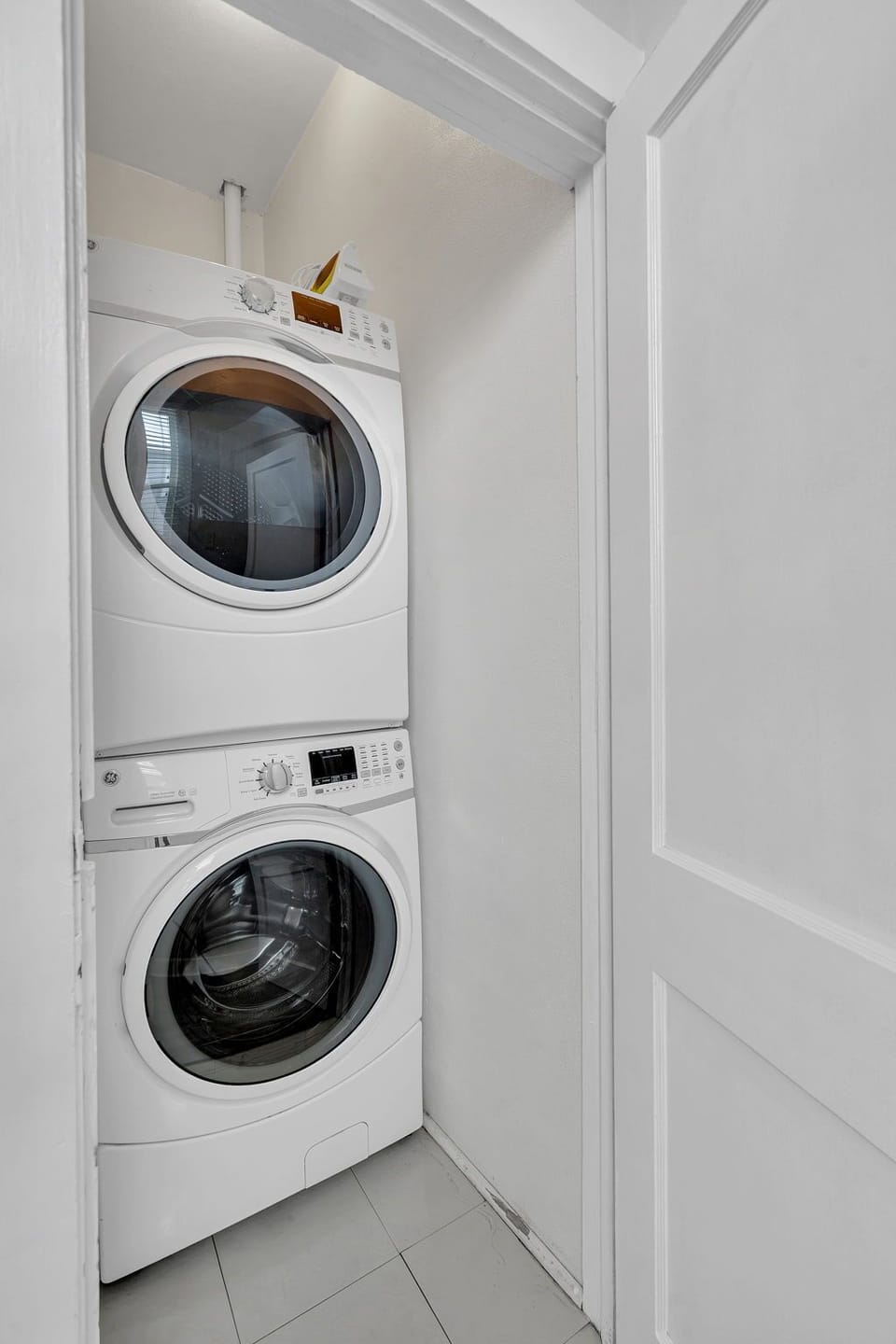In-unit stacked washer & dryer tucked away & ready for longer stays.
