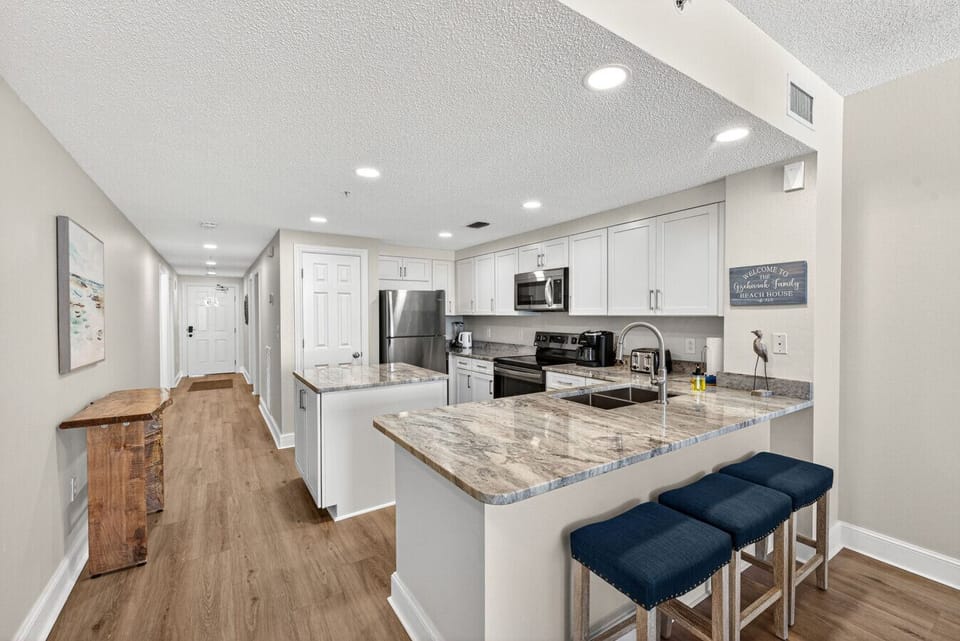 Modern kitchen with ample cabinetry and a clean coastal design.