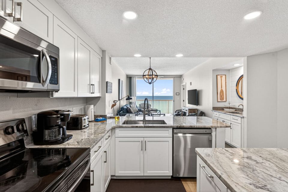 Updated kitchen featuring granite countertops and stainless steel appliances.