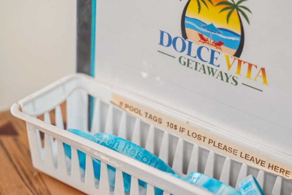 Welcome station with Dolce Vita Getaways pool tags ready for guests to enjoy the resort amenities.