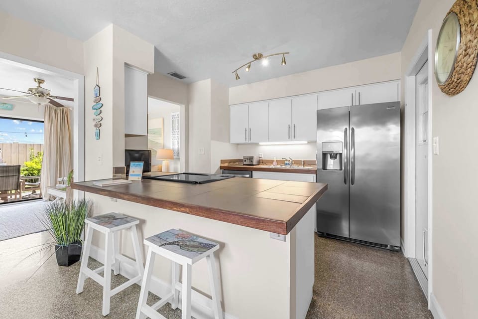 Modern kitchen with stainless steel appliances and a breakfast bar.