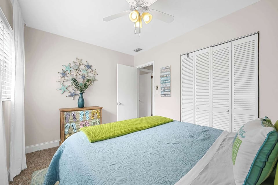 Cozy bedroom with beach-themed decor and natural light from the window
