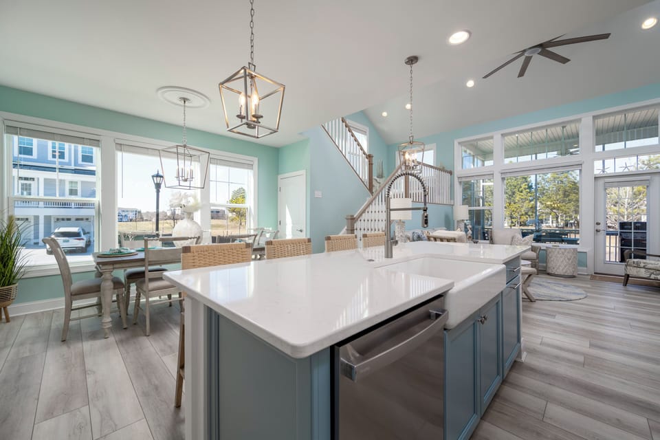 Kitchen Island with farm sink, pull out trash cans and ss dishwasher.