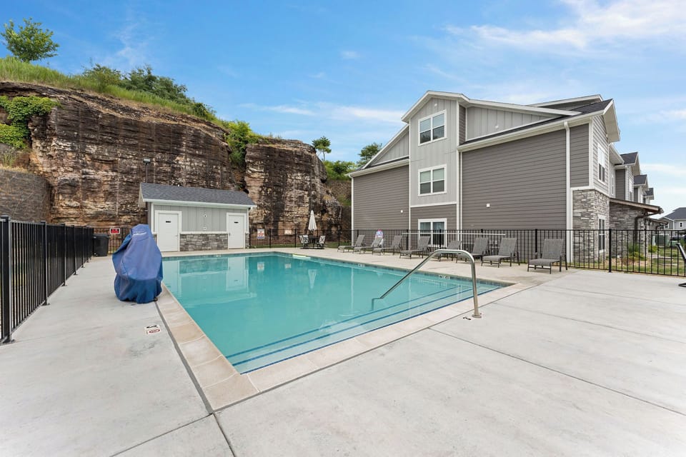 Refresh and relax by this outdoor pool with stunning natural rock views.