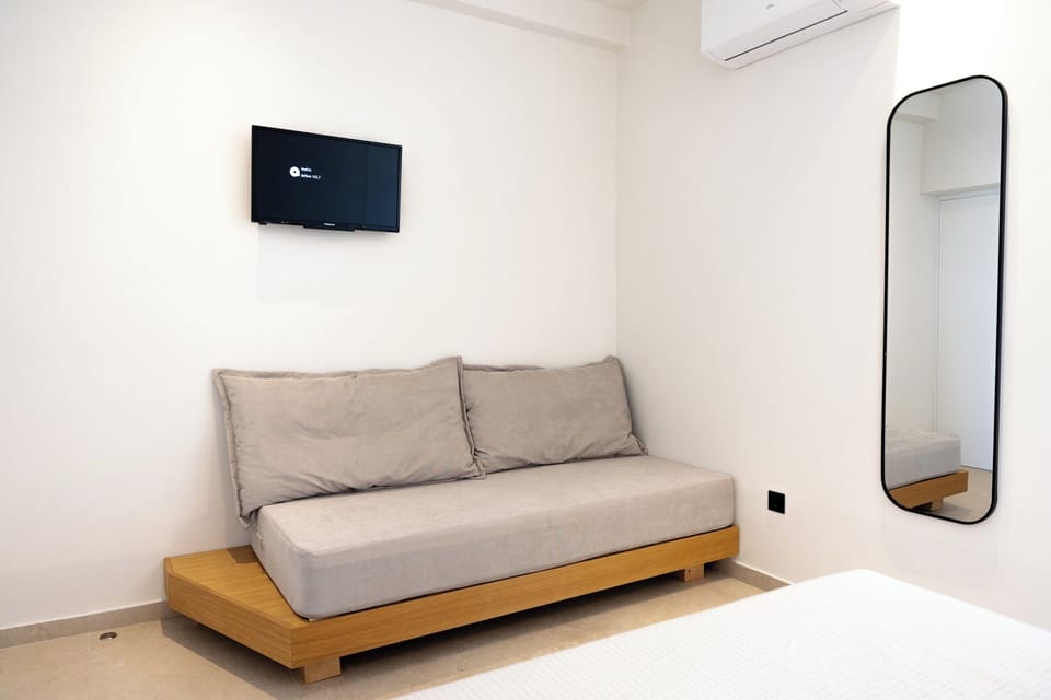 Deluxe Triple Room, Balcony, Sea View | Living area | 32-inch TV with satellite channels