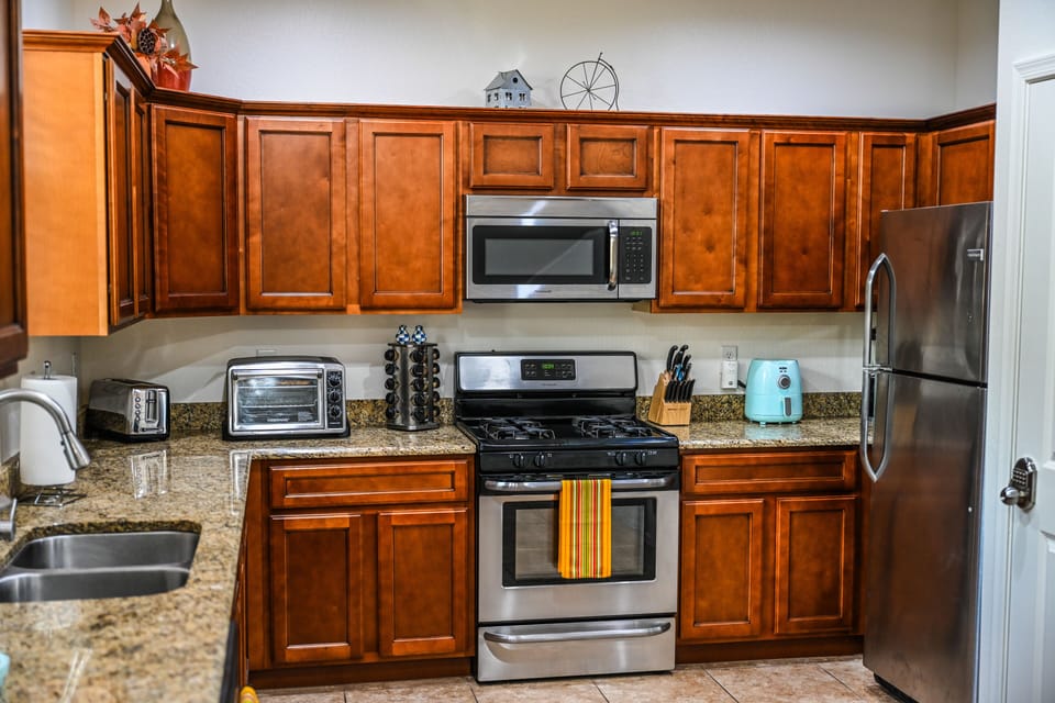 Fully stocked kitchen with a number of kitchen appliances including an air fryer