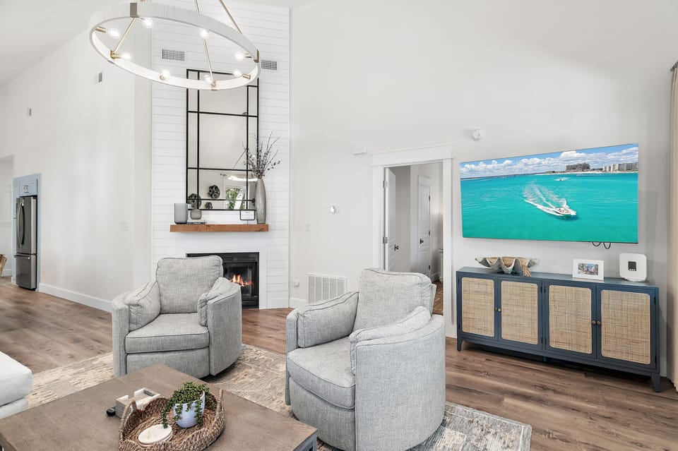 Cozy living area with large TV and natural light