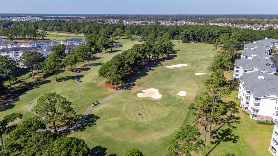 A scenic view of the expansive golf course, with manicured fairways and lush greenery—an ideal retreat for golf lovers and anyone looking to relax in a serene and beautiful environment.