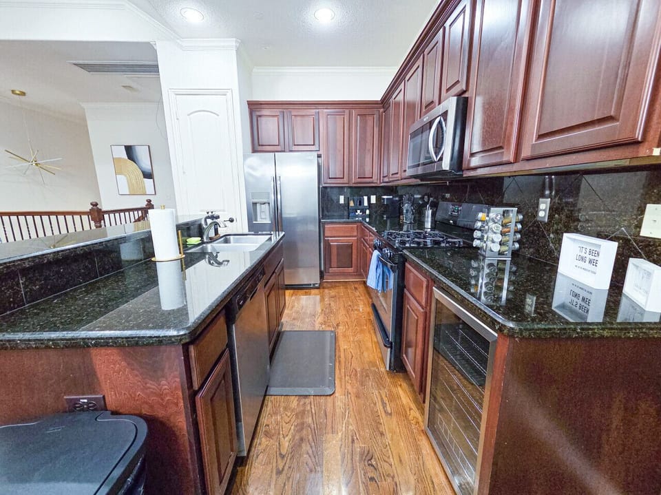 Fully equipped kitchen with stainless steel appliances, ample cabinet space, and a dedicated coffee station to start your mornings right.