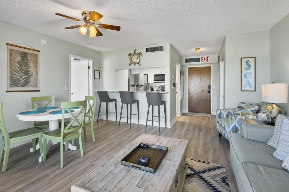The living room flows seamlessly into the dining space, complete with additional countertop seating, making it easy to stay connected to the kitchen.