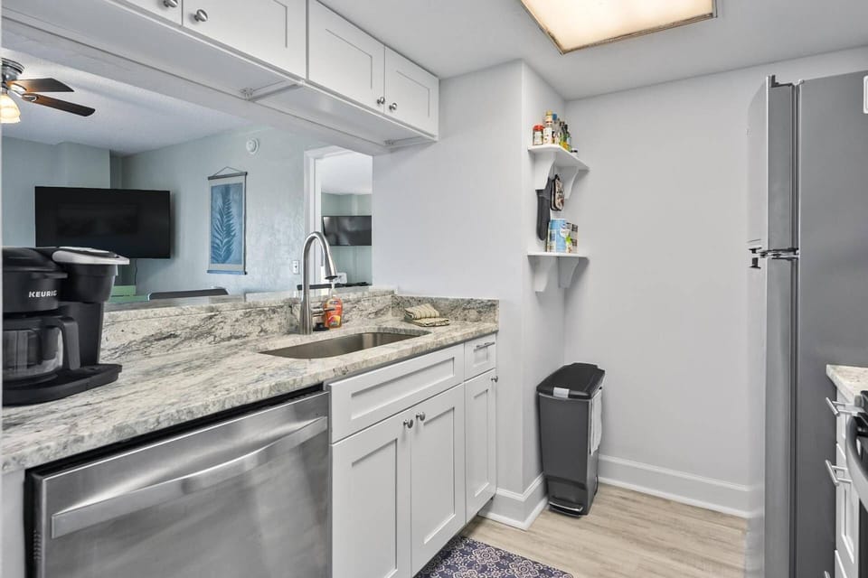 Beautifully renovated kitchen with modern finishes, seamlessly integrated into the open-concept living space.