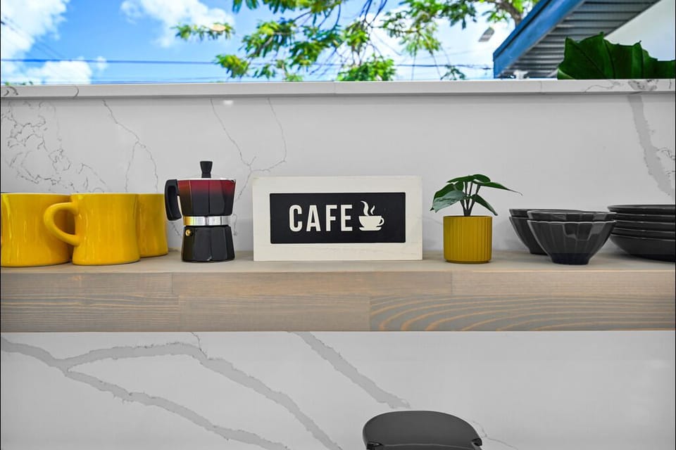 "Charming kitchen shelf with coffee decor and vibrant accents."