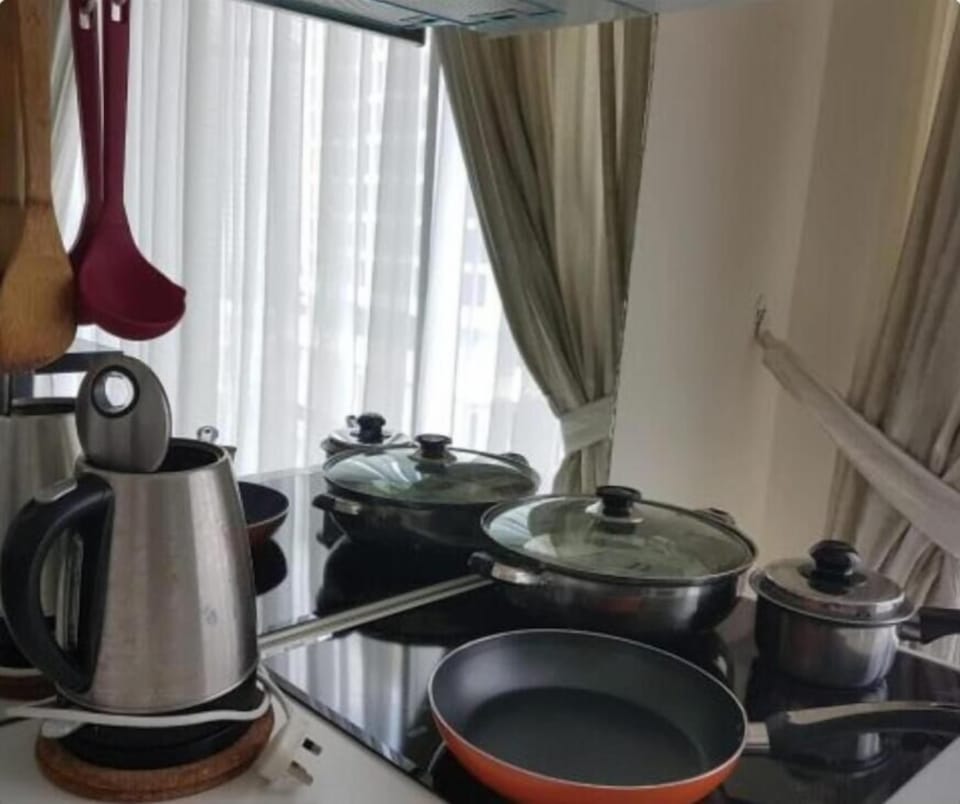 Full-size fridge, microwave, stovetop, cookware/dishes/utensils