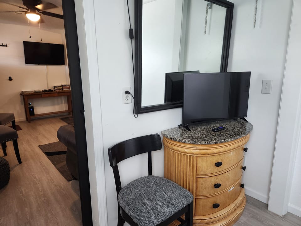 Our 1st queen bedroom has blackout blinds and a smart tv.