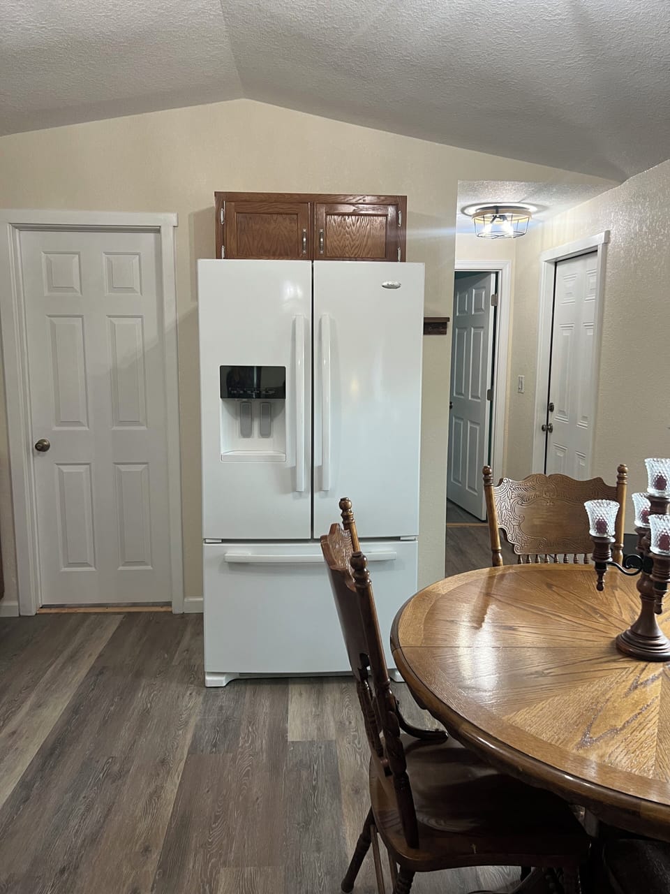 Side by side refrigerator and table with 4 chairs