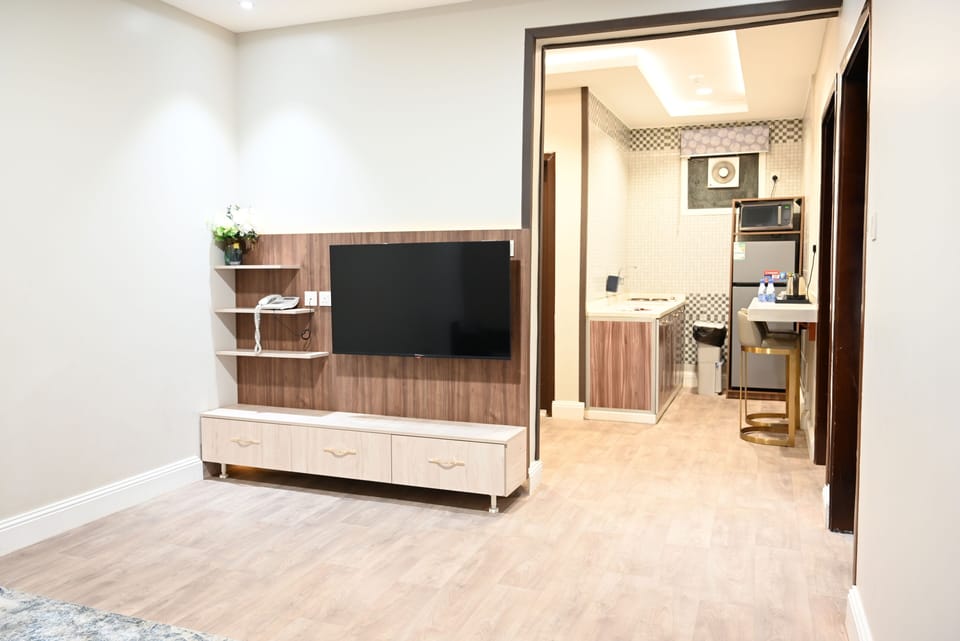 Family Suite | Living area | 120-cm Smart TV with satellite channels