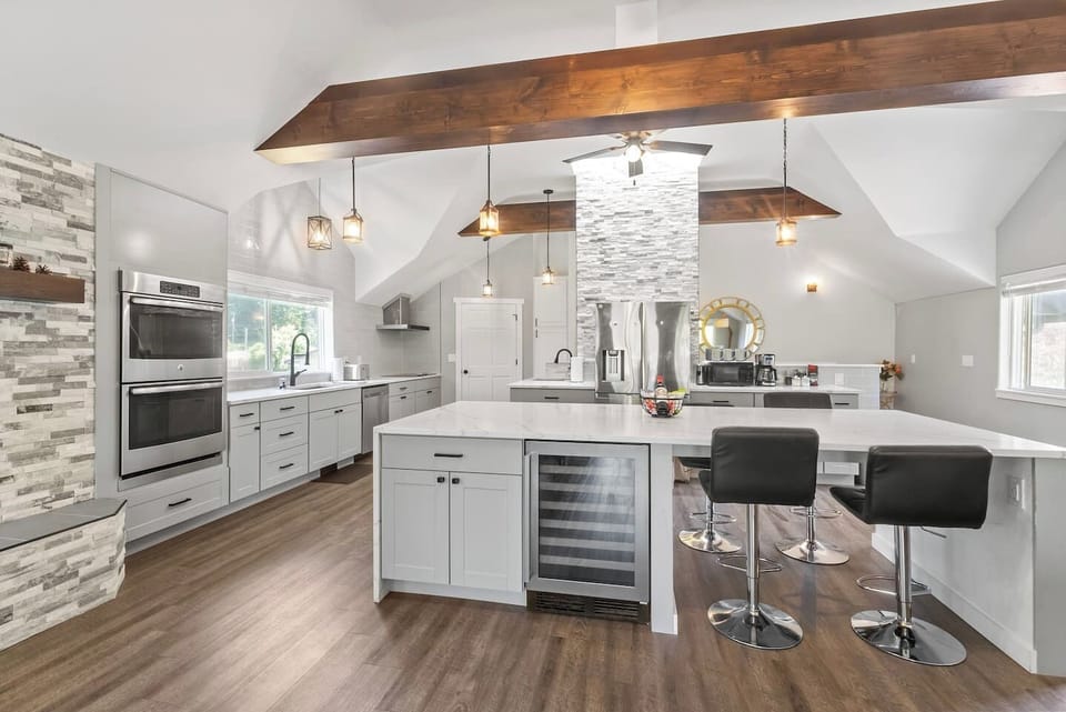 Upstairs Kitchen: Our primary kitchen is a chef`s dream! Extra large island and countertop space allows ample prep room, with a double oven, glass stovetop, dishwasher, bar fridge, and extra stool seating