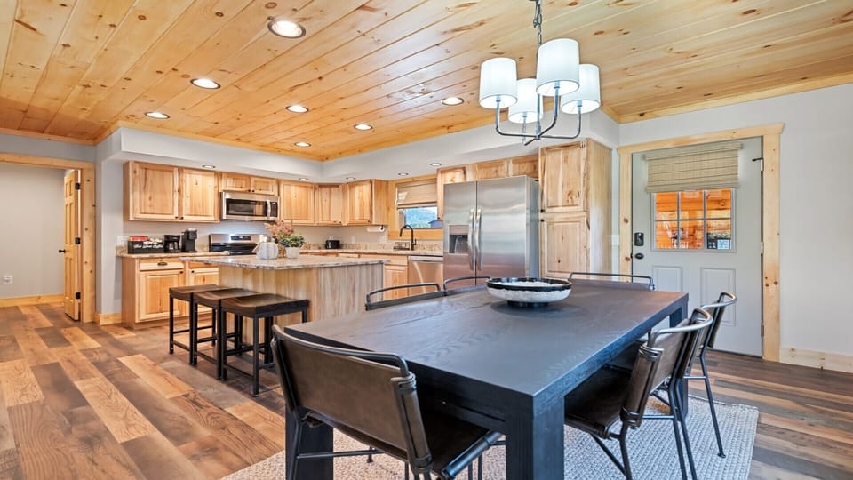 Open kitchen and dining space with warm wooden tones and plenty of light.
