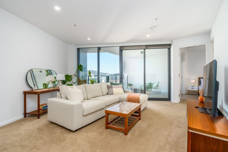 Settle into the inviting lounge area, featuring a plush sofa and smart TV for entertainment.