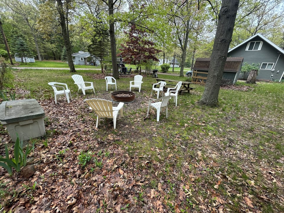 Outdoor fire pit with chairs and table.